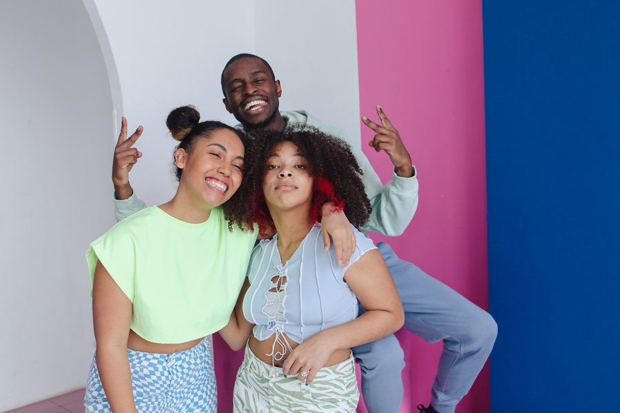 Teenage Friends Posing on Pink Podium